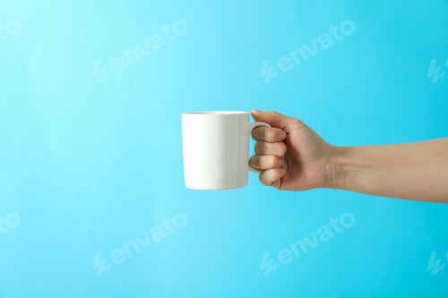 Preview: Female hand holding white cup against color background, space for text