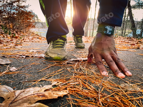 Preview: african American man outdoors on trail about to take a jog wearing smartwatch