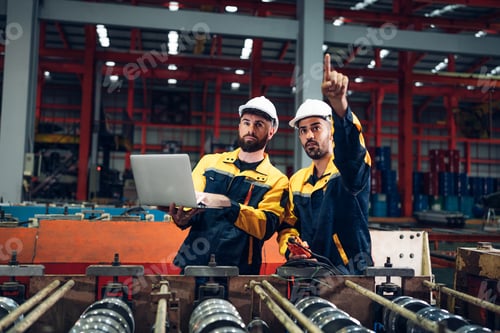 Preview: Industrial man engineer checking system machine at factory.