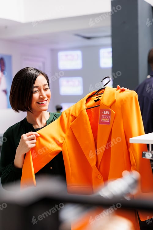 Preview: Happy woman buying clothes with discount