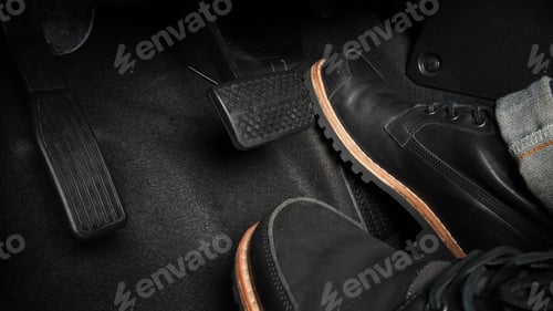Preview: Man foot and accelerator and brake pedal inside the car