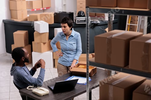 Preview: Warehouse supervisor preparing packages putting customer order in carton box