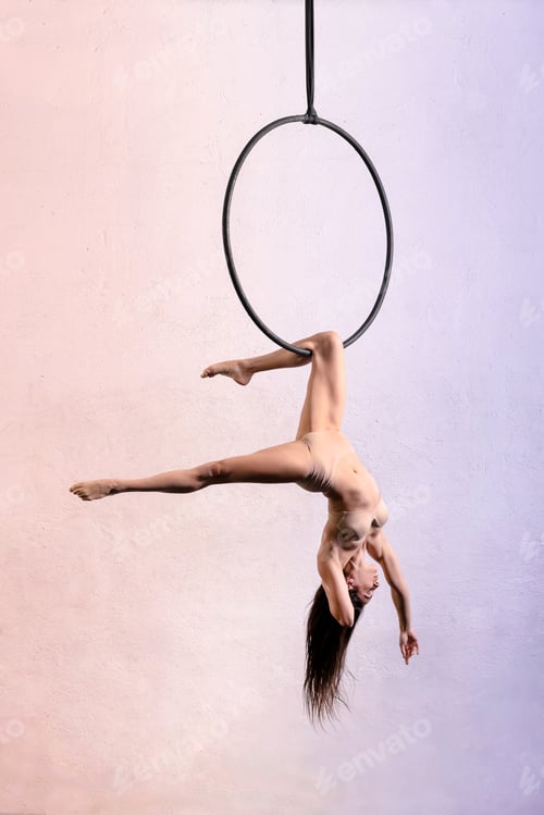 Preview: Athletic Woman Performing Aerial Hoop Acrobatics Indoors