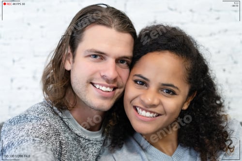 Preview: Portrait of multiethnic couple make selfie recording video vlog from hands with mirrorless camera.