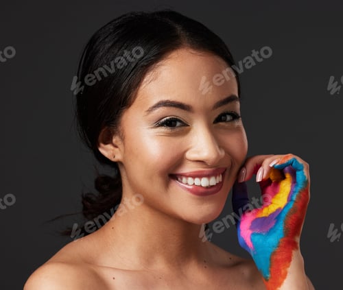 Preview: Woman, portrait and beauty smile with rainbow paint hand or art on and face in studio. Creative ski