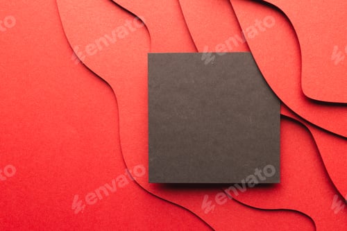Preview: Square of black paper with copy space on red waves of paper on red background