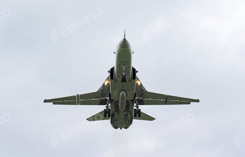 Preview: Military jet bomber Su-24 Fencer flying above the clouds.