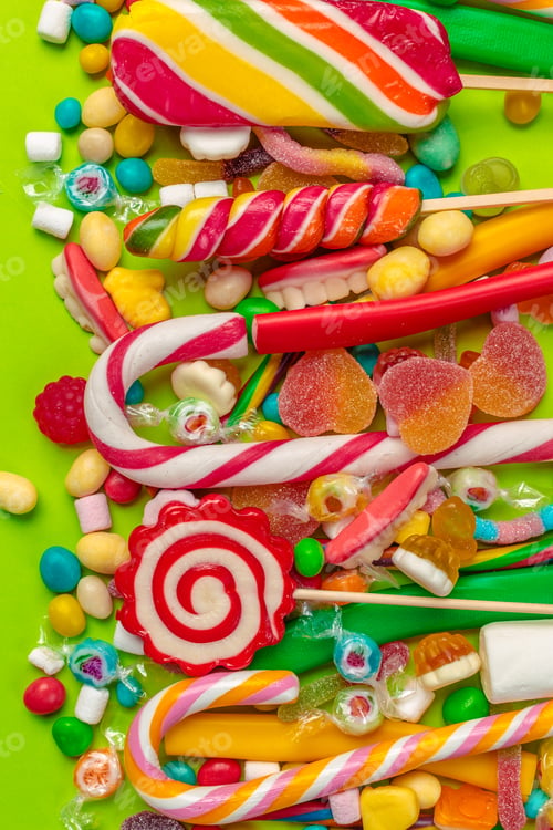 Preview: Colorful candies on green background