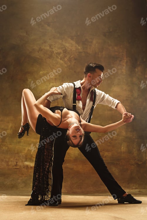 Preview: Flexible young modern dance couple posing in studio.