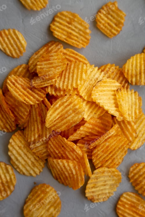 Preview: Crispy Barbeque Potato Chips on a gray surface, top view. Flat lay, overhead, from above.