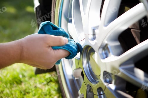 Preview: Close-up of hand cleaning car tire