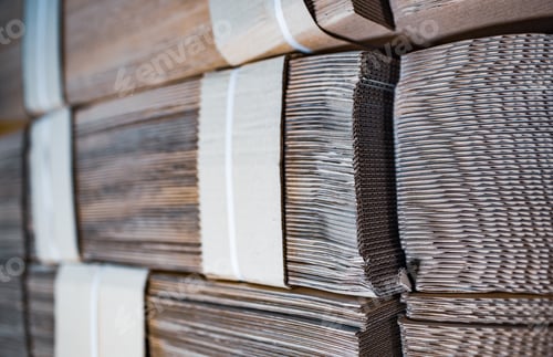 Preview: Close-up sides of stacks of cardboard folded