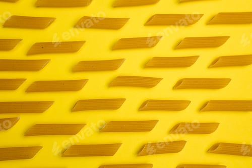 Preview: Pasta and pasta on a yellow background. Macro shot of macaroni on a yellow background. Gluten produc
