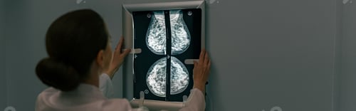 Preview: Back view of professional doctor radiologist looking on scan MRI images in medical center