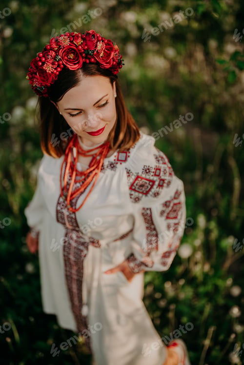 Preview: Attractive ukrainian woman in traditional embroidery vyshyvanka dress, ancient coral beads and red