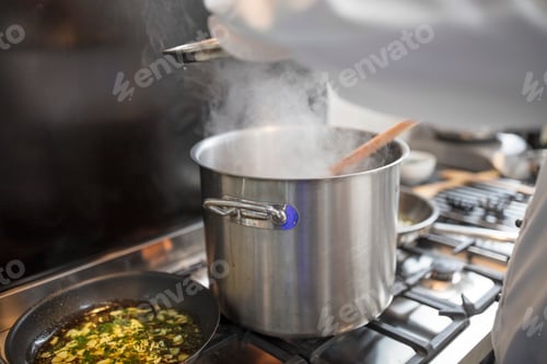 Preview: Chef preparing food in restaurant kitchen