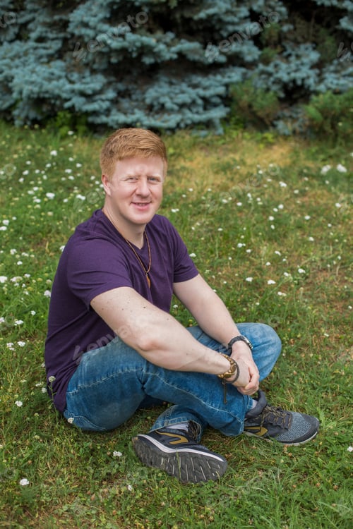 Preview: Man sits on the grass during lunch break