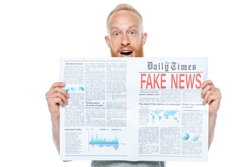 Preview: excited man reading newspaper with fake news, isolated on white