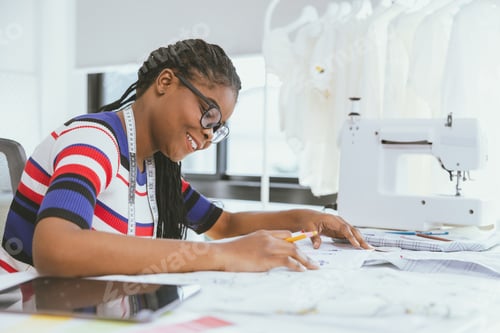 Preview: Happy African black woman working as Tailor Clothes Designer enjoy working