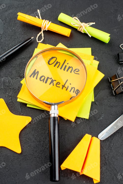 Preview: bottom view online marketing written on sticky notes scroll and star sticky notes scissors binder