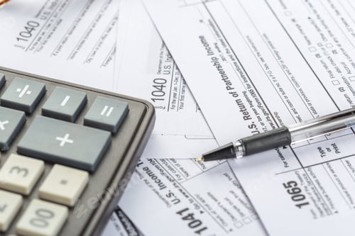 Preview: Documents and tools used for filing taxes in a home office setting