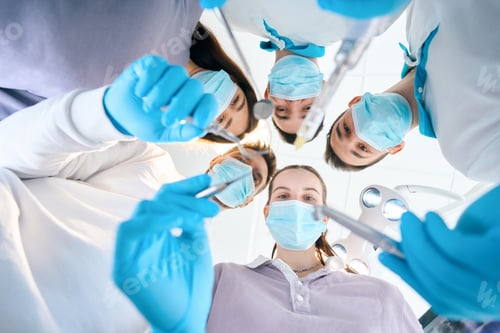 Preview: Team of young dentists with dental instruments in their hands