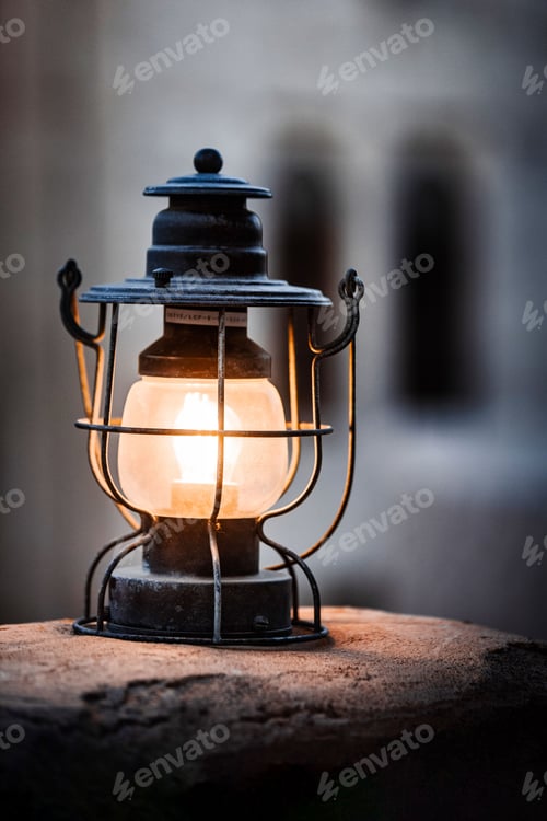 Preview: Antique lamp illuminated atop a weathered stone bench, creating a cozy atmosphere in the room