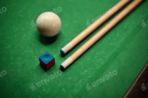 Preview: Closeup cue, ball and chalk on billiard table