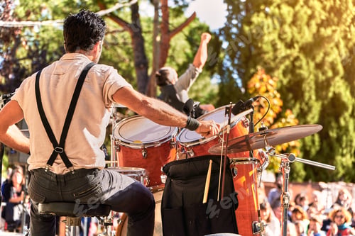Preview: Summer music festival at the park. Music band playing on the stage
