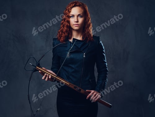 Preview: Redhead female holds crossbow.