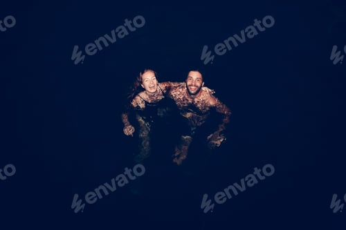 Preview: Couple playing in the dark water