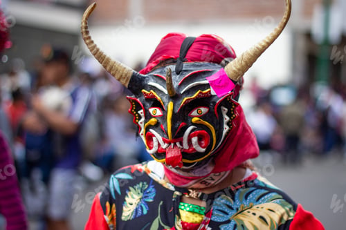 Vista previa: Performer wearing traditional horned mask at latin american festival