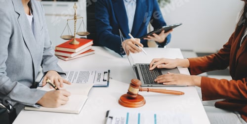 Preview: business people and lawyers discussing contract papers sitting at the table.