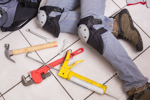 Preview: Plumber Fixing Under The Sink In The Kitchen