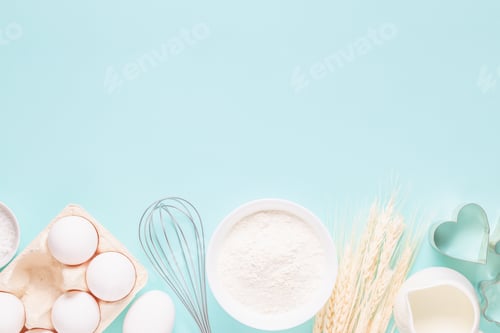 Preview: Ingredients for baking on light blue background.