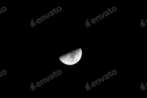 Preview: Tranquil image featuring a half moon suspended against a night sky, illuminated by the soft glow