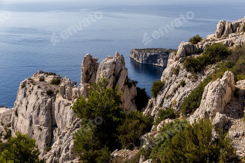 Preview: aerial view of high cliffs, green vegetation and calm sea in Calanques de Marseille (Massif des