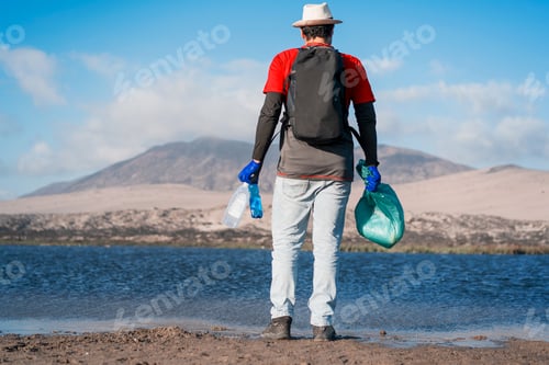 Preview: volunteer collects plastic waste on the beach
