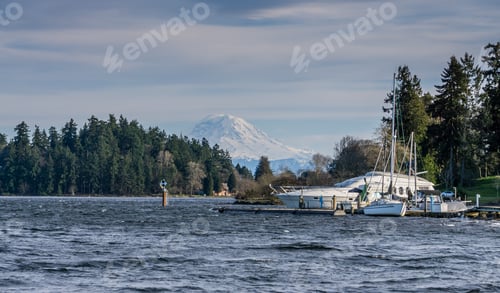 Preview: A Boat Is Moored Along Lake Washington With Mount Rainier In The Distance.
