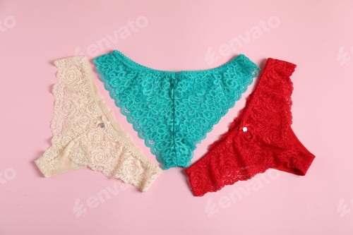 Preview: Women's underwear. Beautiful panties on pink background, flat lay