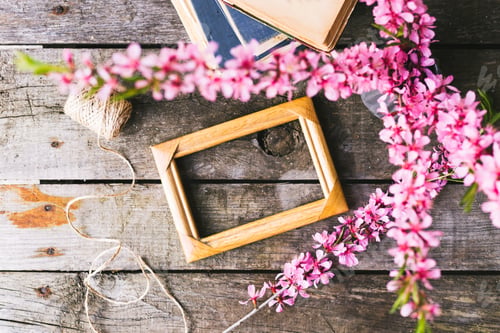 Preview: Spring flowers frame and book on a old wooden background