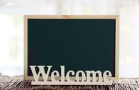 Preview: Welcome Sign with Chalkboard on Brown Wicker