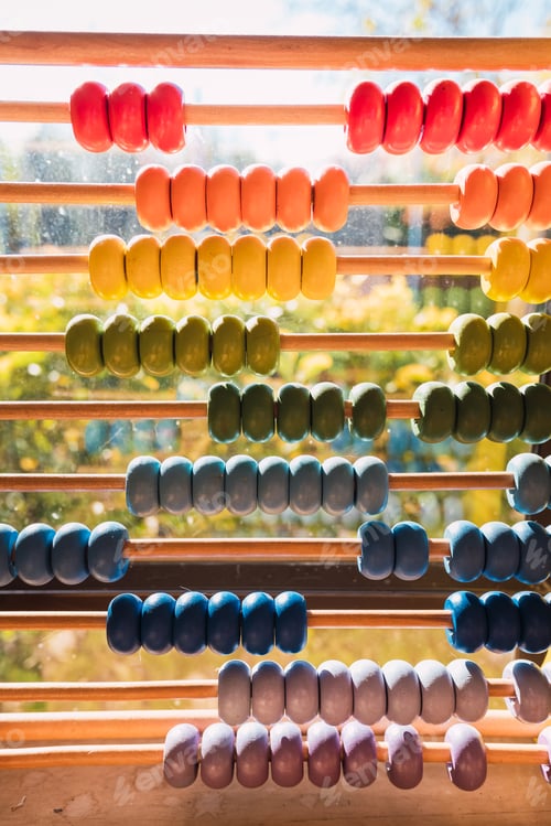 Preview: Detail of the colored beads of a wooden abacus, elementary educational material.