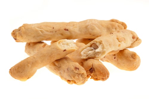 Crisp Breadsticks Stacked on Bright White Background