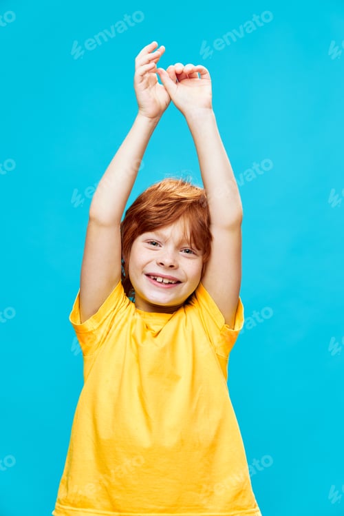 Preview: Happy child smiles and raised his hands up on background.