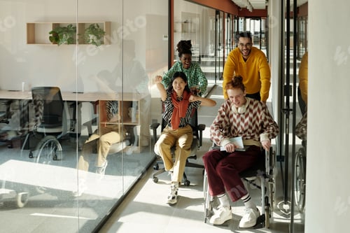 Preview: Laughing Young Adults Collaborating in Creative Coworking Office Corridor