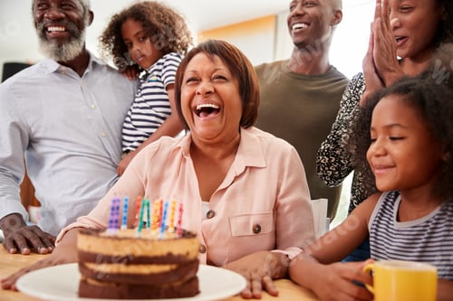 Preview: Multi-Generation Family Celebrating Grandmothers Birthday At Home With Cake And Candles