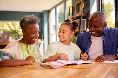 Preview: Multi-Generation Family With Grandparents Helping Granddaughter With School Work At Home