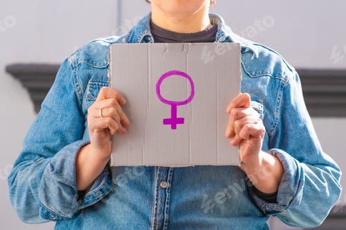 Preview: Woman holding cardboard sign with female symbol. Feminist concept, feminism, feminist activist