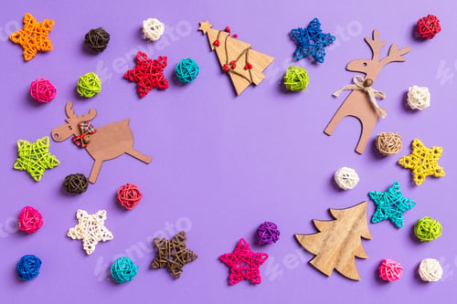 Preview: New Year decorations on purple background. Festive stars and balls.